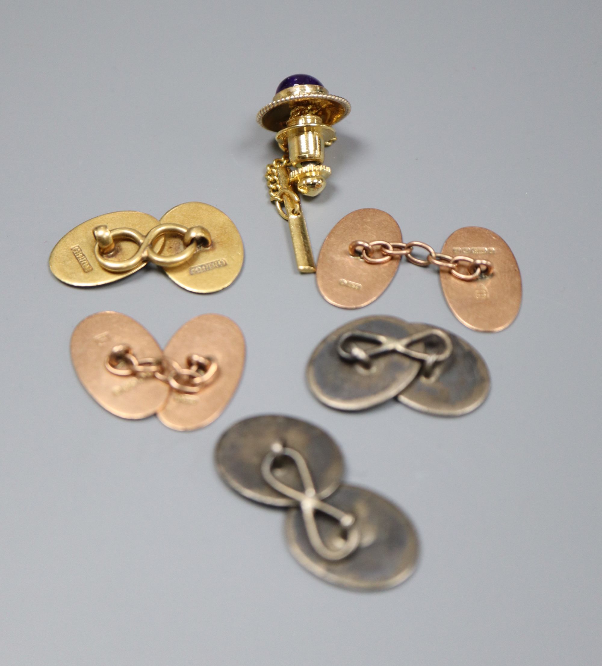 A pair of 9ct gold cufflinks, an 18ct cufflink, a 14k and amethyst dress stud and a pair of white metal cufflinks